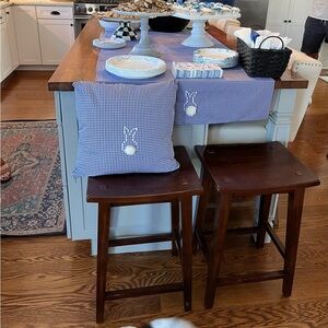 Two blue gingham table runners with embroidered bunnies at each end